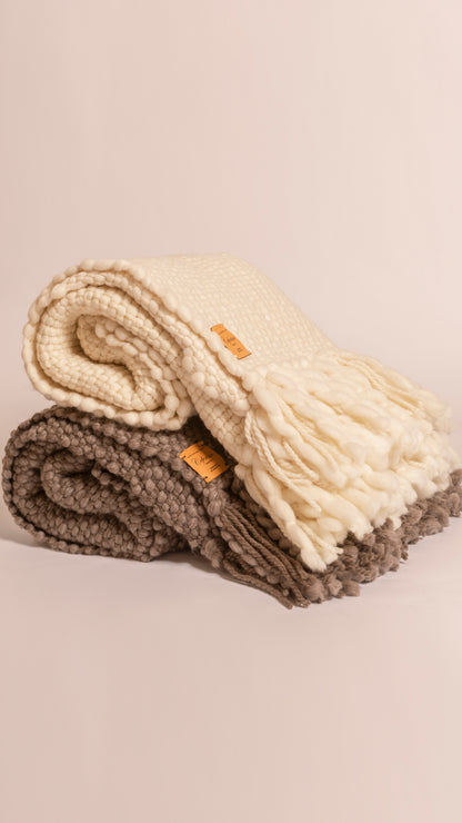FLAMA HERITAGE THROW in White off and Grey - Side profile of two stacked hand-woven wool throws showing fringe and leather brand tags
